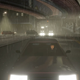 GTA III's protagonist drives toward the camera on a rainy night.